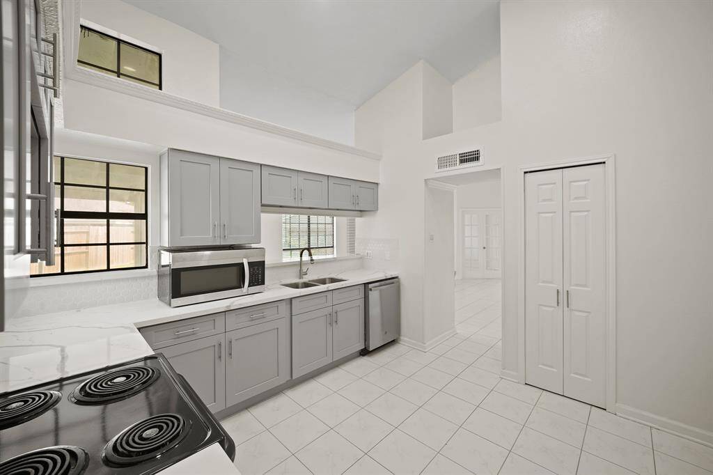 Charming kitchen with lovely backsplash. Plenty of cabinet and counter space. Pantry as well. Lots of natural light.