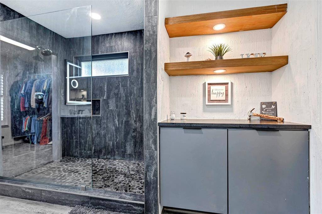 Sleek, fully renovated master bath with a modern design.