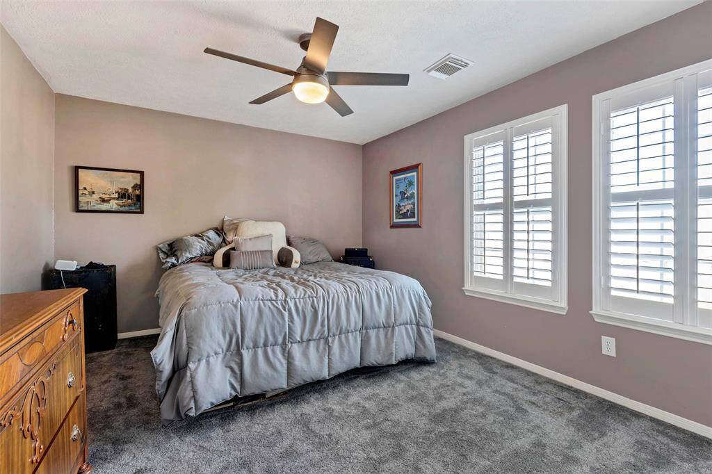 Expansive secondary bedroom offers ample space and natural light.