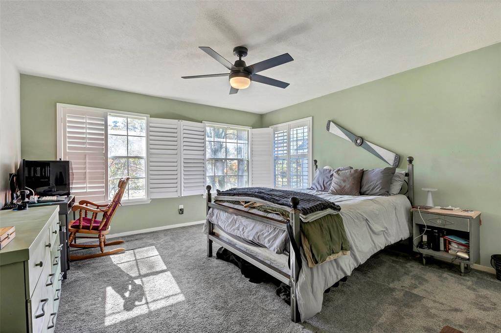 Expansive bedroom with abundant natural light and modern features.