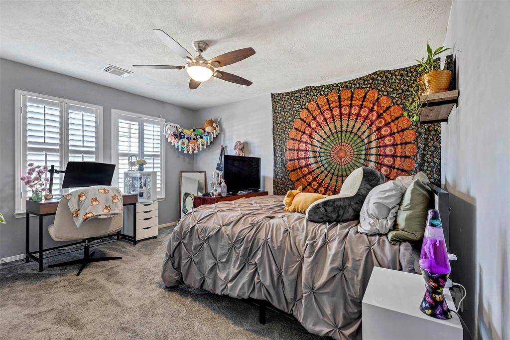 Spacious secondary bedroom with abundant natural light.