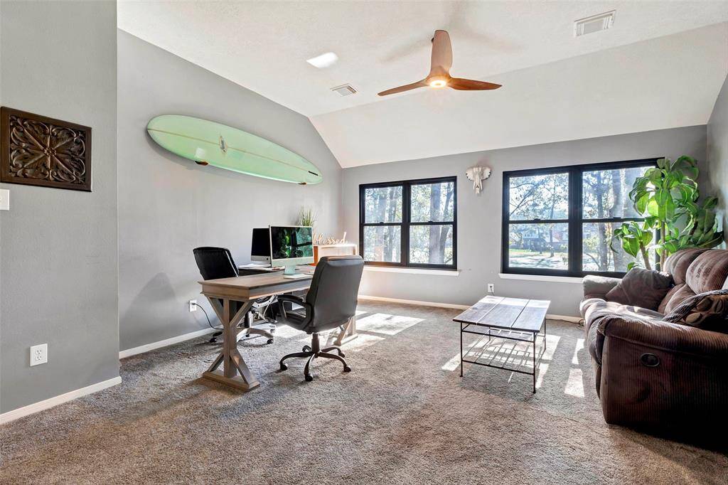 Expansive game room with abundant natural light and versatile space for entertainment and relaxation.