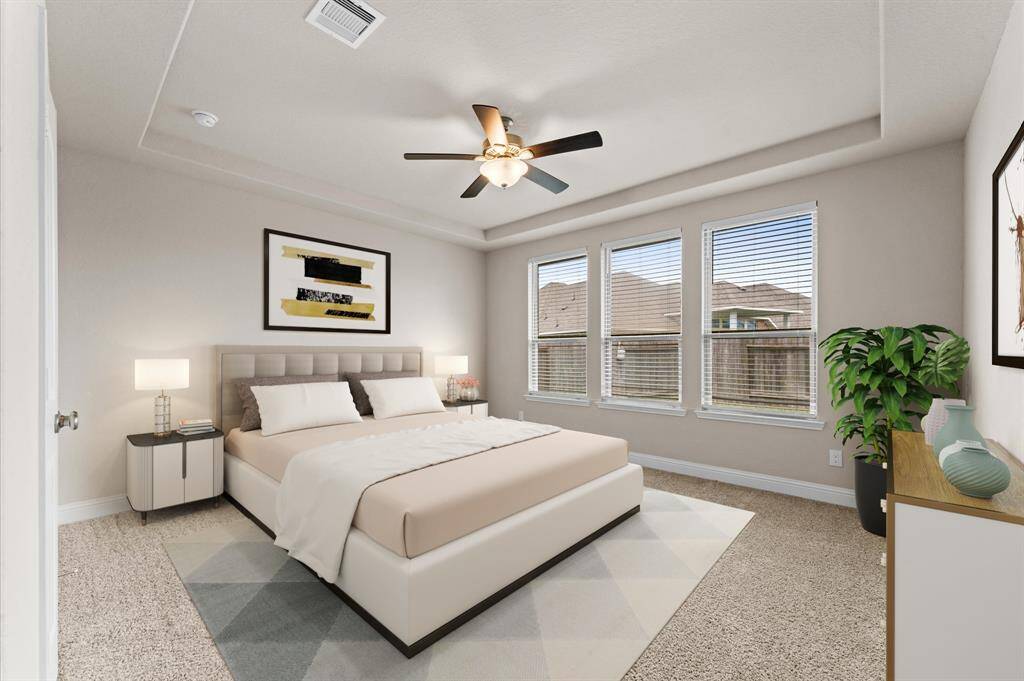 Retreat to a spacious master suite designed for comfort and tranquility. Wide windows frame a serene backyard view, filling the room with soft, natural light.
