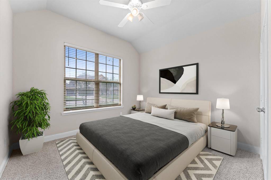 This bright and cheerful  second bedroom is perfect for relaxation or productivity. Soft carpet flooring and wide windows create a warm and inviting atmosphere.
