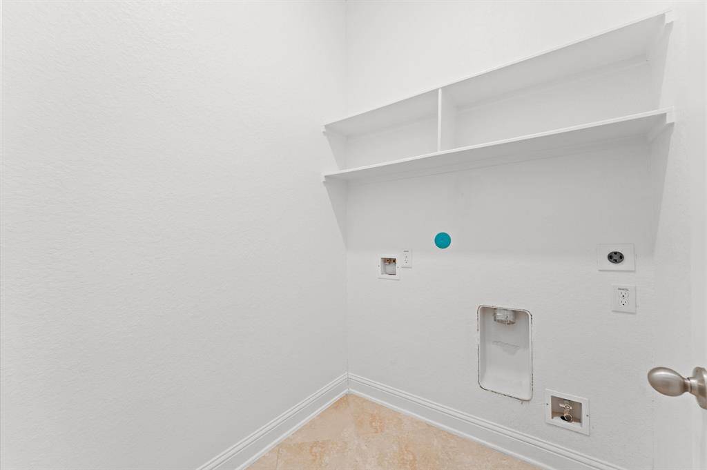 Designed for convenience, this laundry area makes everyday tasks a breeze. This well-planned space blends practicality with comfort, adding to the home's thoughtful design.