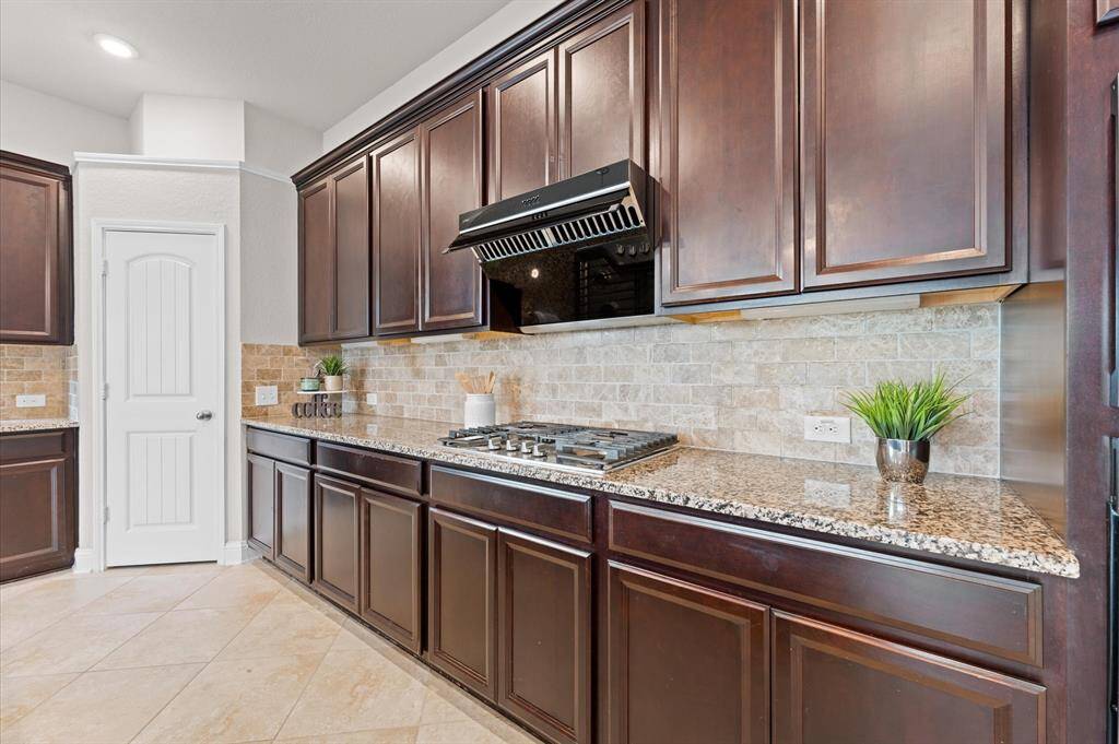 Custom elegant cabinets provide ample storage, while stainless steel appliances add a modern touch.