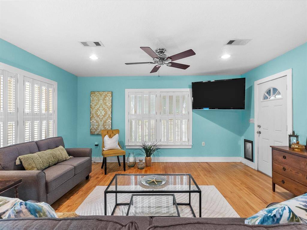 Large open concept living roon with 4 windows that are double-paned & all have window coverings.  Additionally, there is a doggy door for all your furry friends.