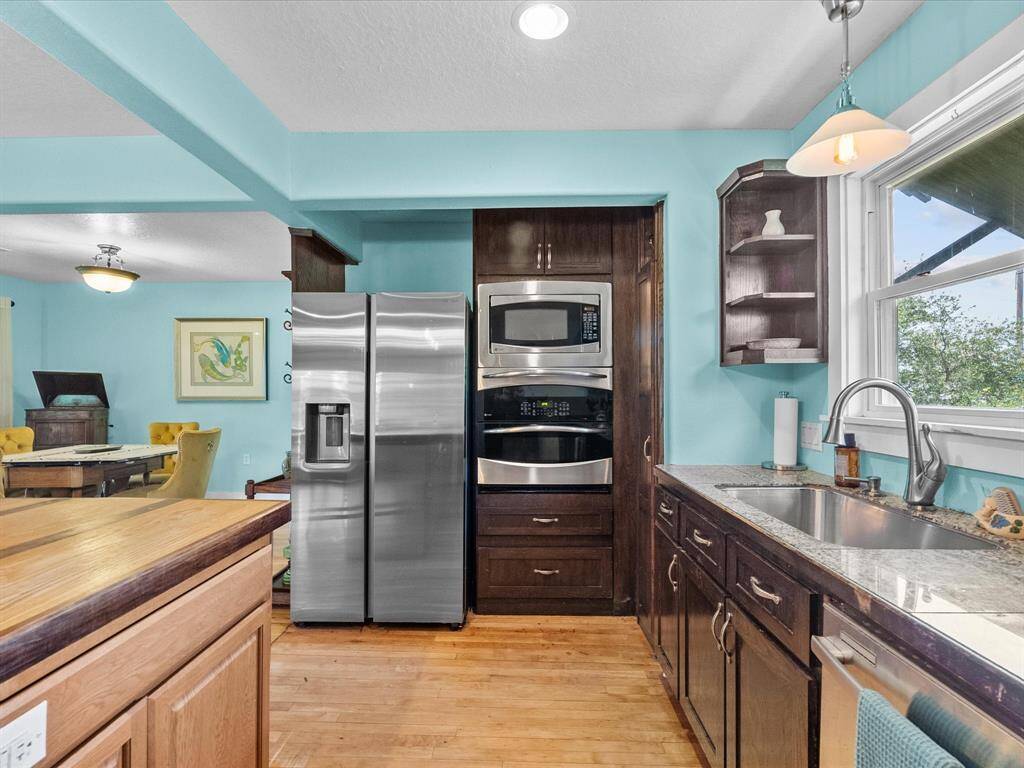 Home features new stainless steel appliances. Included in the home is everything you see here - dishes, coffee maker, DOUBLE OVEN, microwave, & refrigerator.