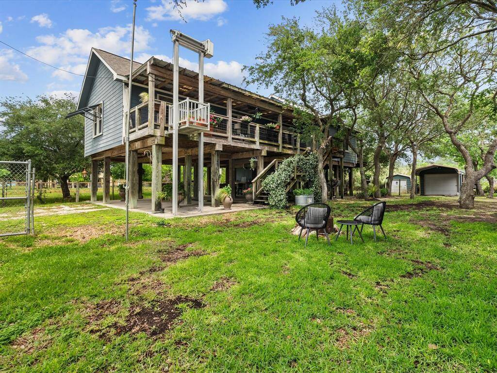 It sits on a large, full fenced lot with mature trees and a cozy outdoor seating area, perfect for enjoying nature. Outdoor fire pit perfect for enjoying nighttime outdoors.