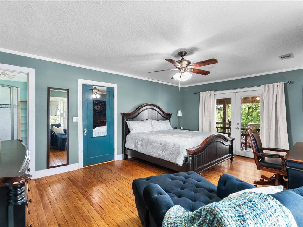 This Primary bedroom features water views from both large windows, french doors that open to the front porch patio.  A ceiling fan & lots of natural lighting.