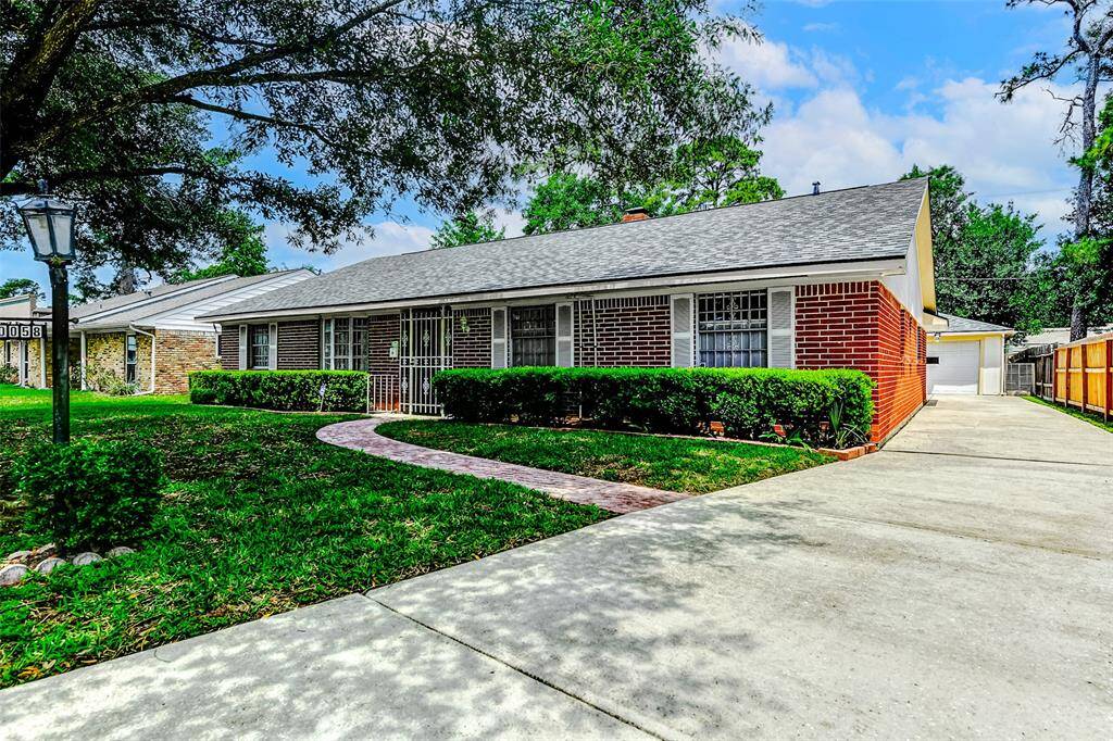 Charming curb appeal awaits at 10058 Haddington Dr with a wide driveway, fresh roof, and manicured front landscaping. Set beneath mature trees, this classic brick traditional home offers timeless style and a welcoming first impression in the heart of Spring Branch.