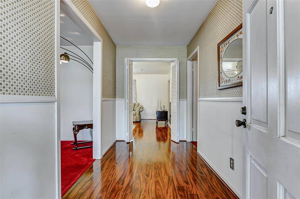 Step inside to gleaming wood floors and a bright, airy entry that leads to spacious living and dining areas. Vintage wallpaper and abundant natural light set the stage for creating your dream interior while preserving the home's timeless character.