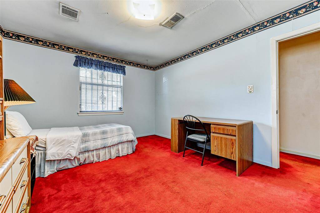 This light-filled bedroom offers flexibility for sleep, study, or play. Features include built-in desk space, closet storage, and charming touches throughout. An inspiring blank canvas for future updates!