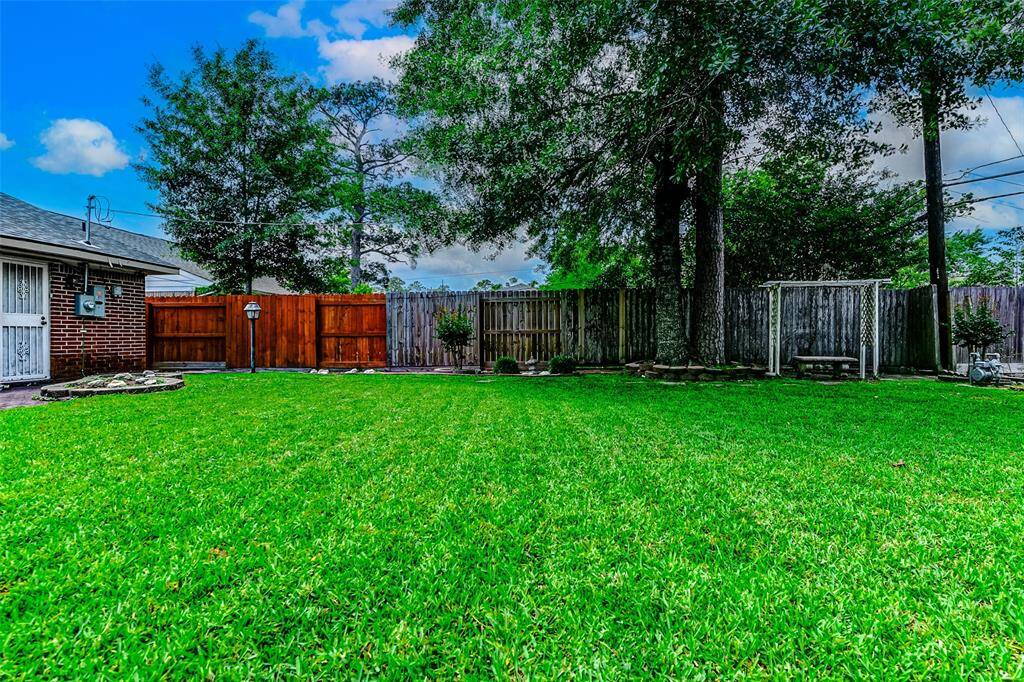 Enjoy the serenity of this expansive backyard with mature shade trees, a charming swing area, and a secure wooden fence. The perfect canvas for your dream outdoor lifestyle!