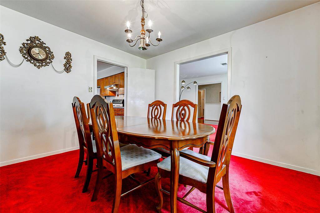 Classic design meets everyday convenience in the heart of the home. The formal dining area easily connects to the remodeled kitchen, offering effortless flow for entertaining and family meals. Vintage clock detail adds character.
