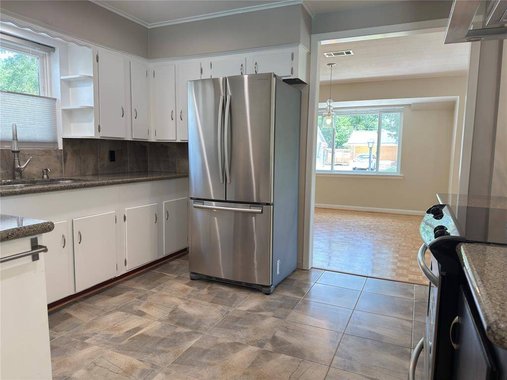 Shiny stainless steel appliances and granite countertops