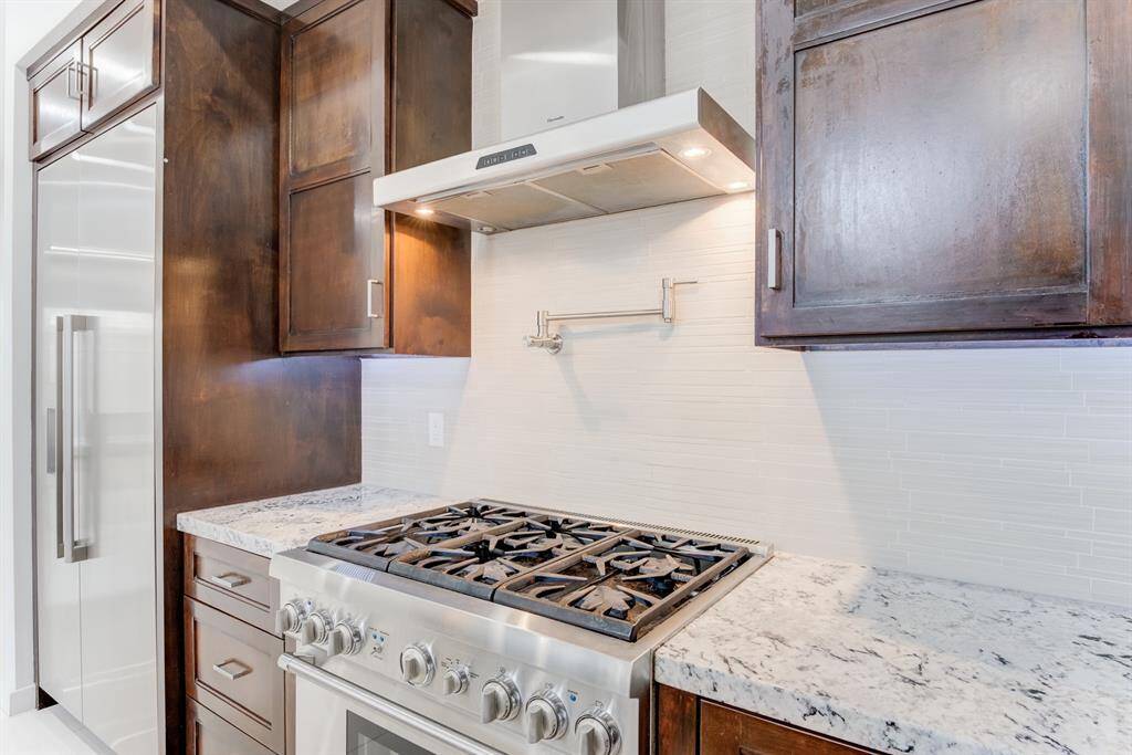 Thermador gas stove with a stainless steel hood is perfect for cooking enthusiasts.