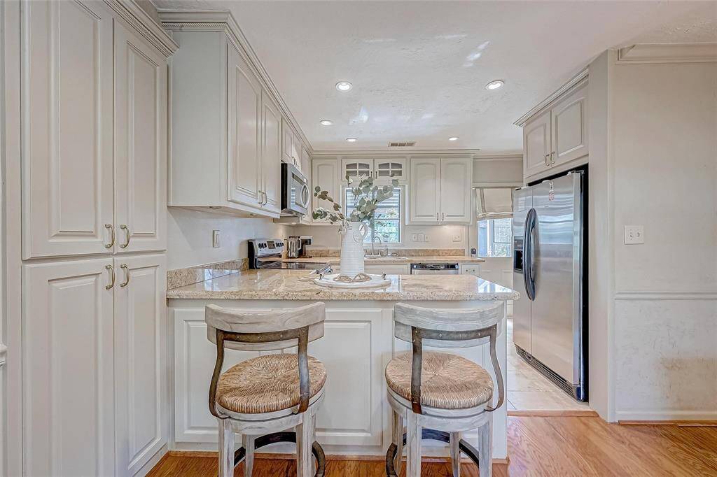 The kitchen has a beautiful granite island, under cabinet lighting and a garden windows - because wow, this garden is one that should be seen!