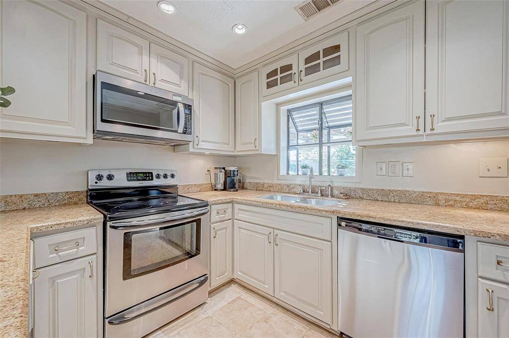 Gorgeous kitchen with under cabinet lighting and in cabinet lighting as well.  Garden windows overlook back gardens, which are incredible.