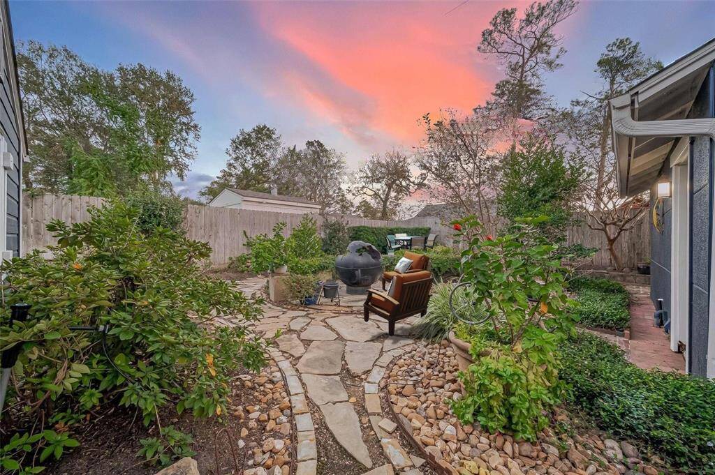 Walkway from the pergola leading up to the firepit and patio areas.