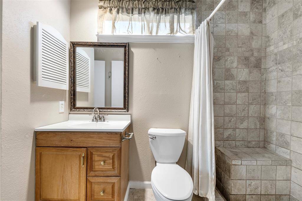 Bath featuring shower with sitting bench