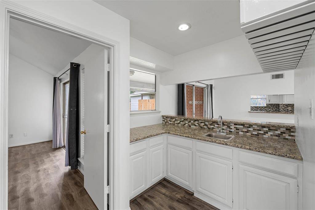 Wet bar off of the formal dining room with granite countertop and lots of cabinets.