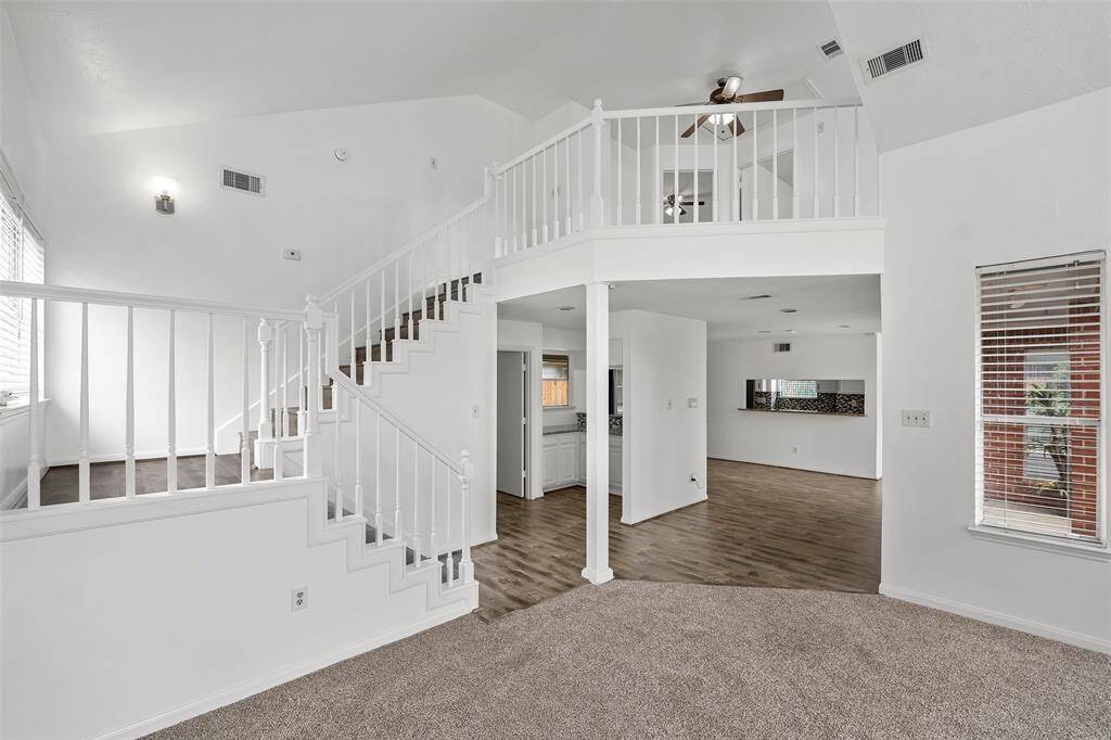 Wood staircase leads you to the recently carpeted and painted upstairs.