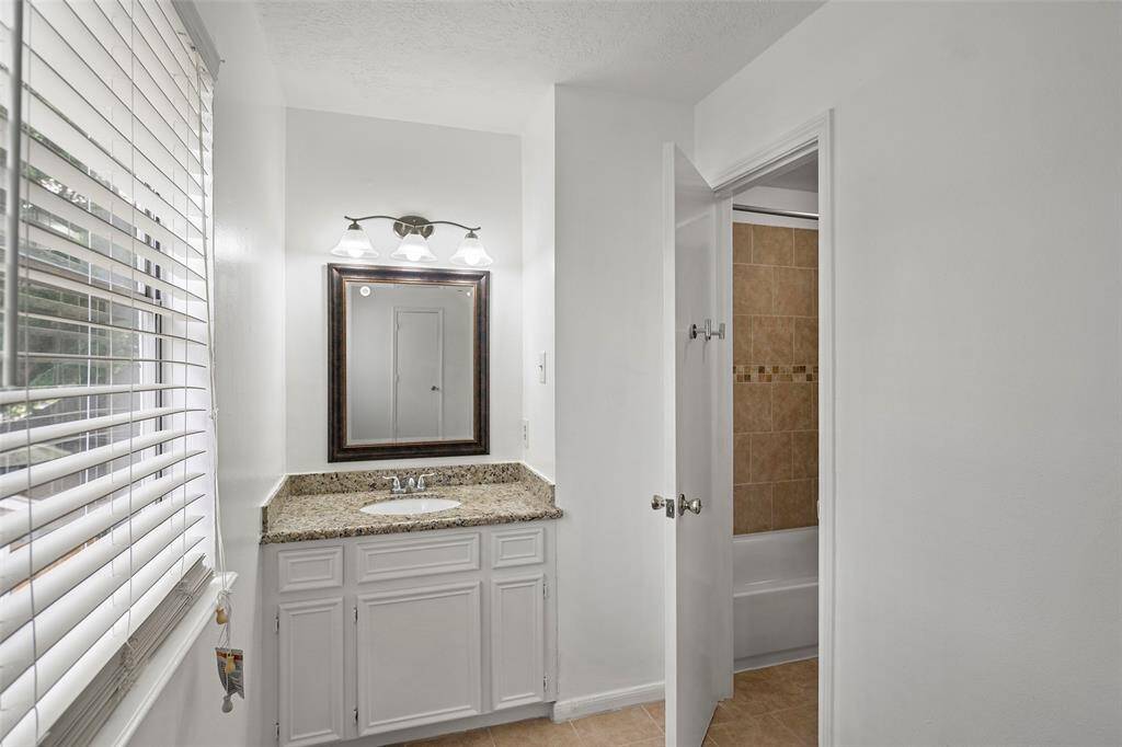 Bedroom #3's sink area with granite countertop.