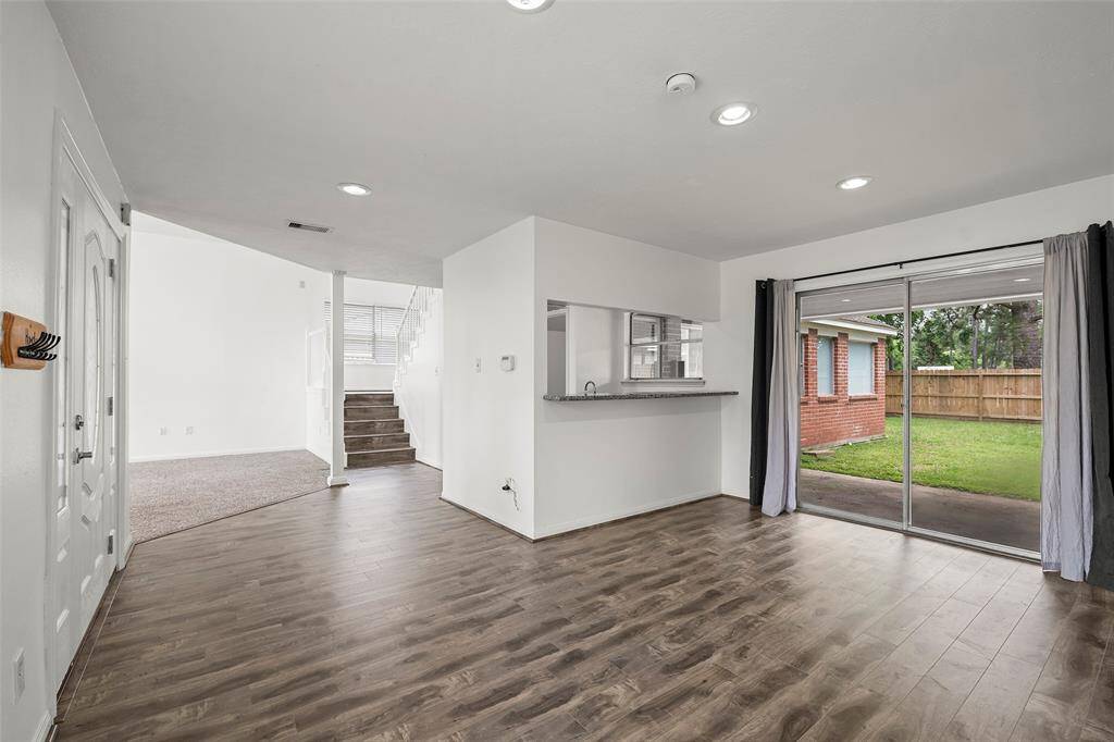 Formal dining room with a wet bar. Sliding glass doors open to the covered back patio.