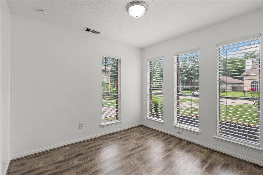 Well-lit breakfast area with new wooden floors.