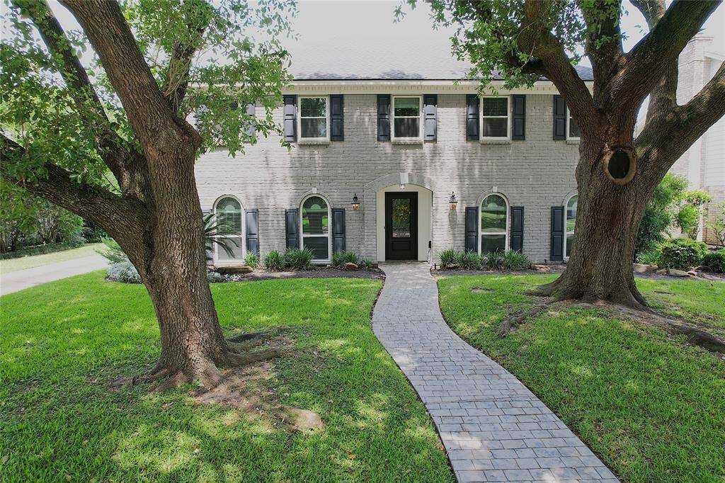 Welcome to 10906 Dunbrook Drive with beautiful mature trees.