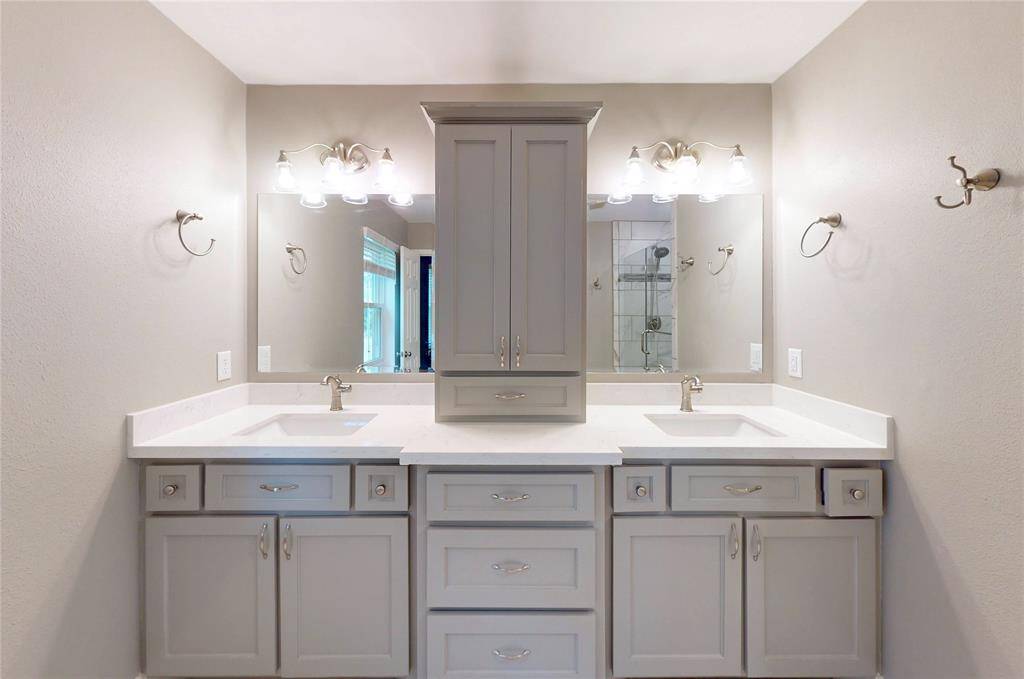 The primary bath has been completely remodeled with new cabinets, mirrors, fixtures, and all hardware.