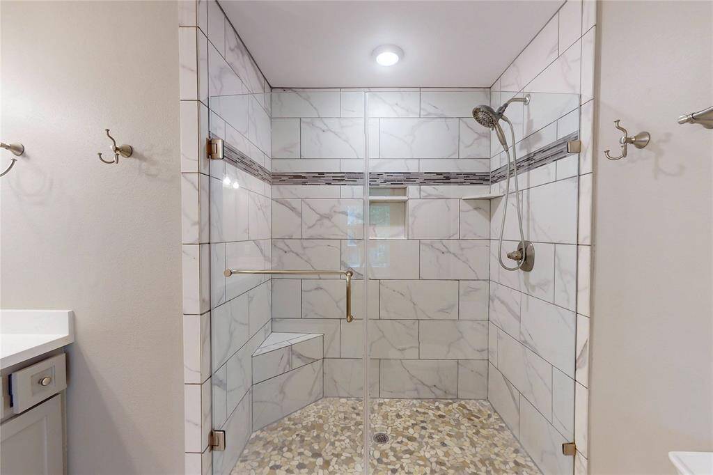 Primary bath shower has been remodeled with this elegant walk in shower.