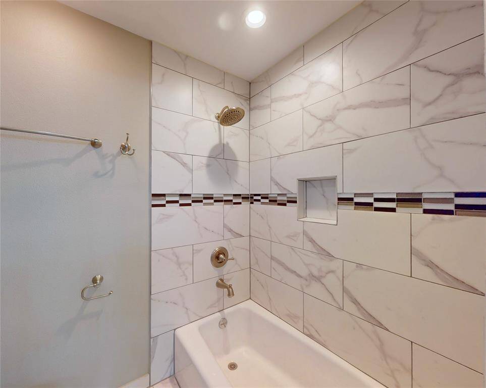 Upstairs bath has a new commode and updated shower.