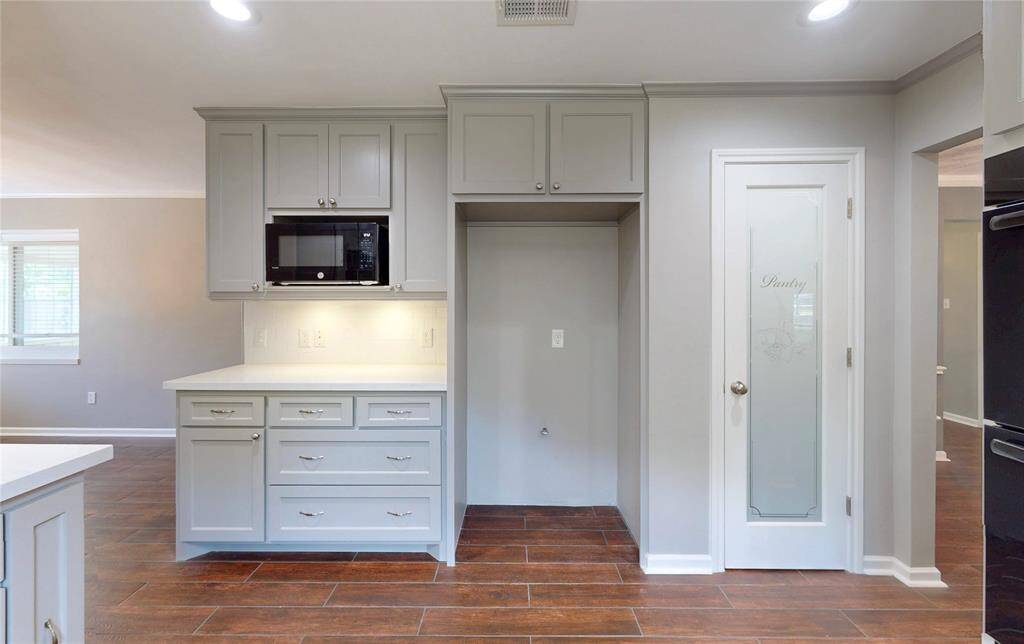 Another view of the kitchen with the new microwave and pantry door.