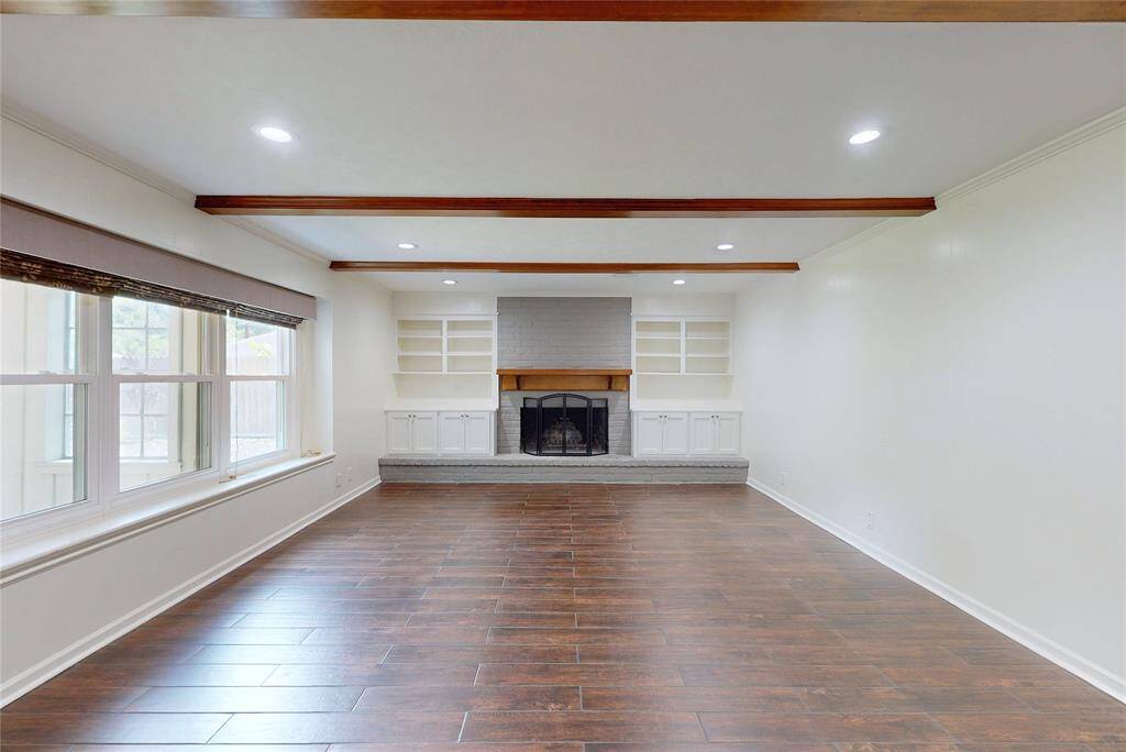 The family room features a wood burning fireplace with a gas starter and custom blinds on the windows.