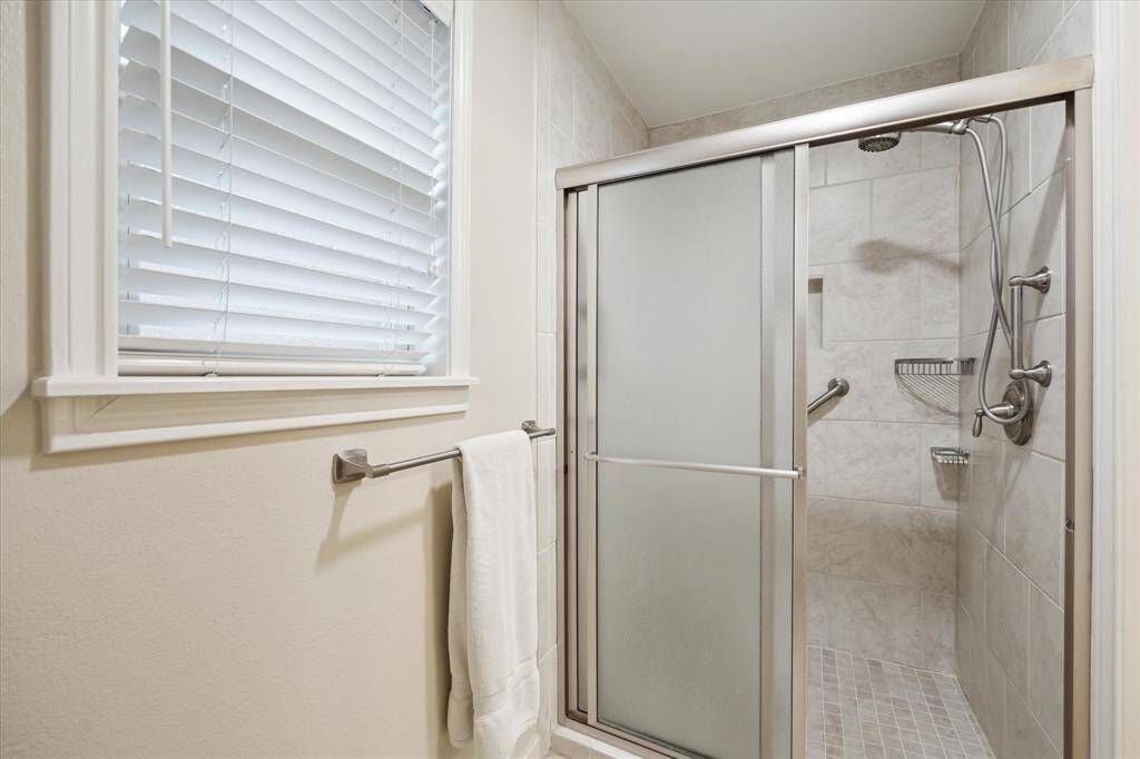 The updated shower has a low threshold entry and grab bars for extrasafety.