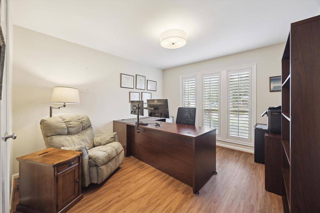 This is the fourth bedroom (currently used as an office). It has a walk-incloset and large windows with a front view.