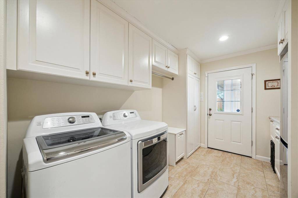 The laundry room has plenty of storage, a clothes rod, built-in laundrybasket, coat closet, and cleaning closet (not pictured).