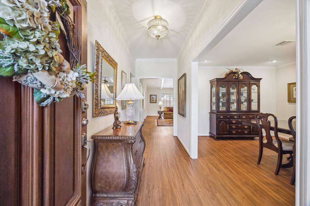 The entry foyer provides quick access to the dining room, family room,and bedroom wing. Beautiful wood flooring (LVP) provides a sense ofcontinuity throughout the whole house.