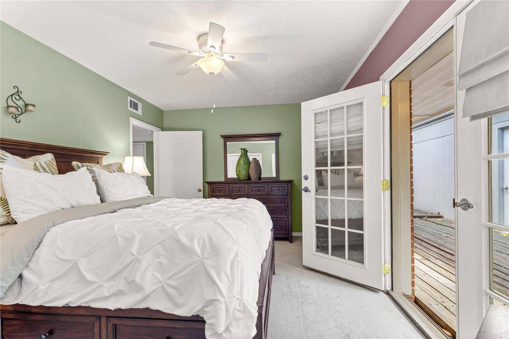 Primary Bedroom with french doors leading to deck outside!