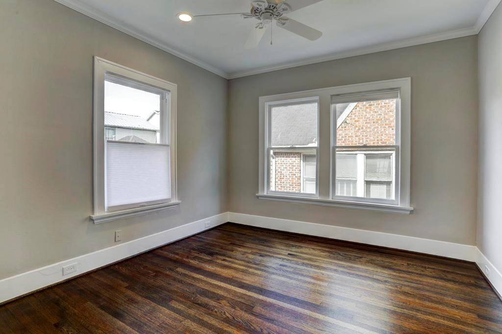 Back bedroom with huge windows (with new top down bottom up shades) 6" LED recessed cans, ceiling fan, walk in closet and original wood floors.