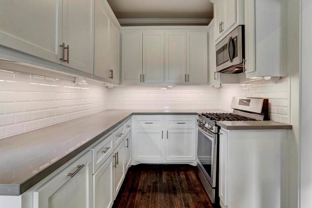 New kitchen with with soft close cabinets and drawers, contemporary hardware, stone counter tops, beveled subway tile back space and LED under counter lighting. New stainless steel gas oven - range and microwave with exhaust that vents outside.