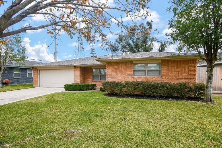Charming front exterior framed by mature plants and well-maintained landscaping.