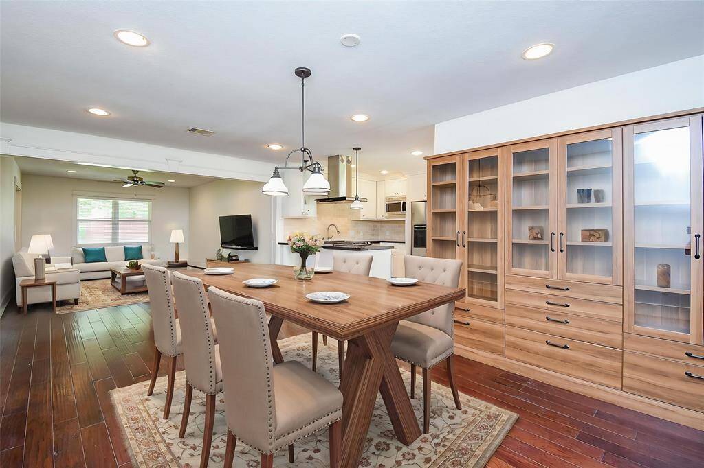 Bright and airy dining space virtually staged to show flow into the kitchen, with charming French door behind.