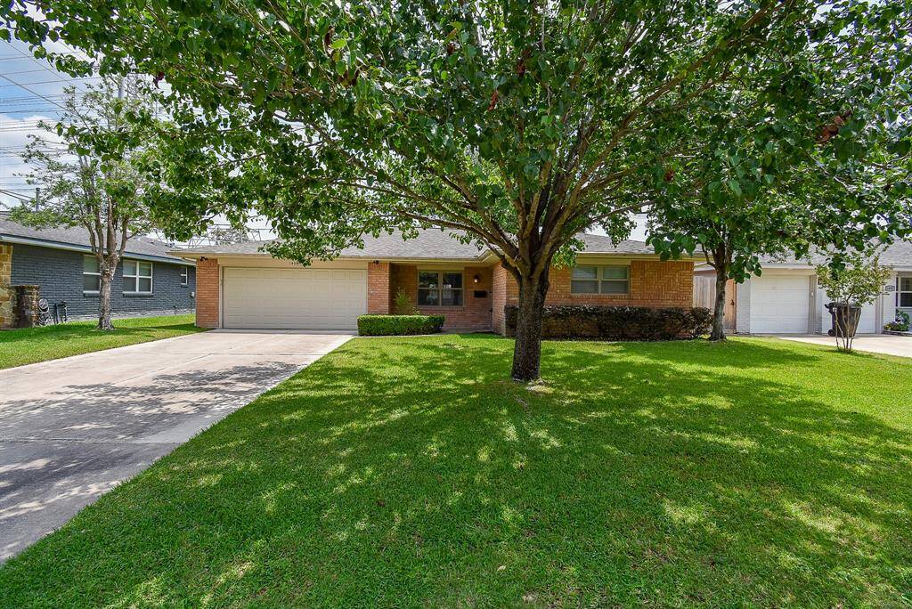 Charming front exterior framed by mature plants and well-maintained landscaping.