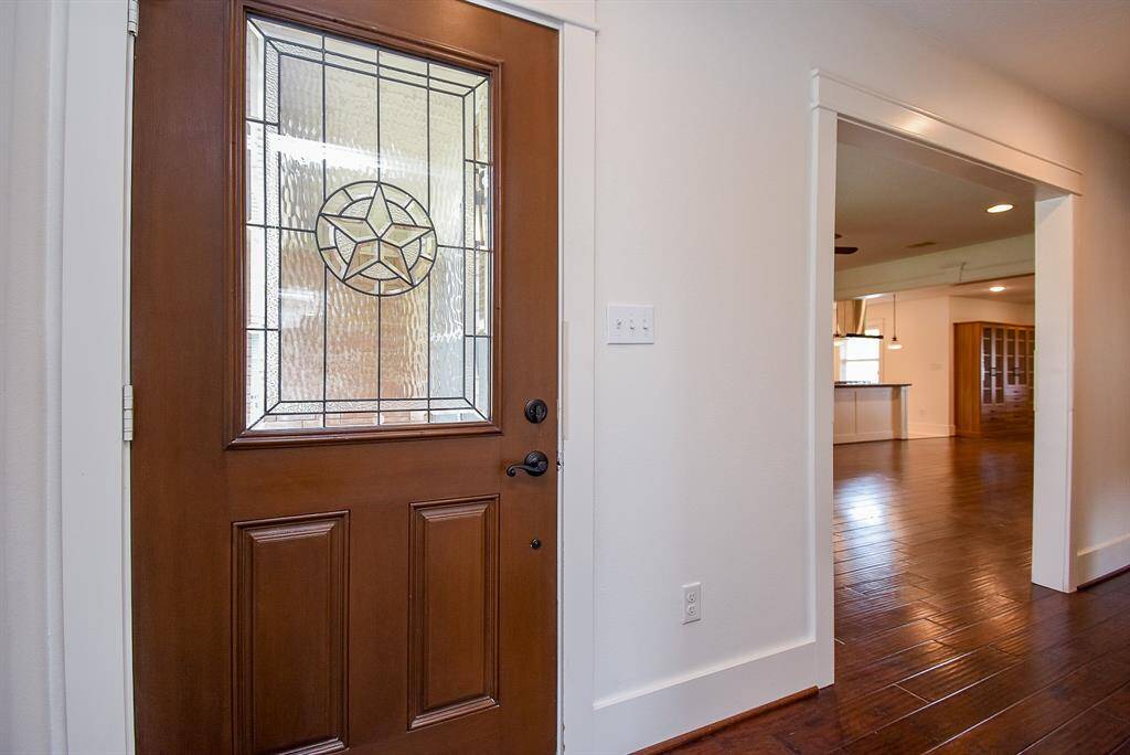 Inviting entryway highlighted by a stunning wood and fiberglass front door with a classic Texas star motif.