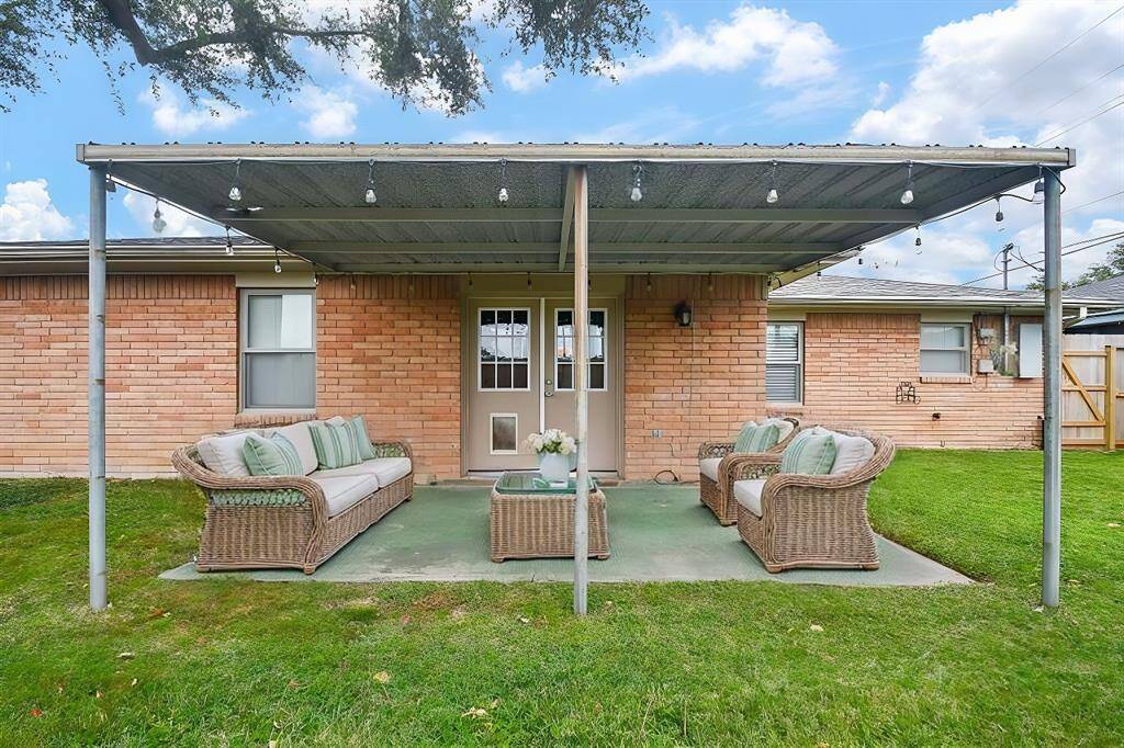 Virtually staged covered patio, perfect for relaxation or gatherings, with a large yard and no back neighbors for added privacy.