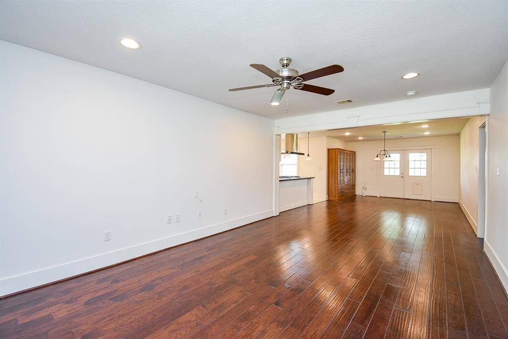 Beautiful, high-quality wood flooring flows seamlessly through the living, dining, and hallway spaces.