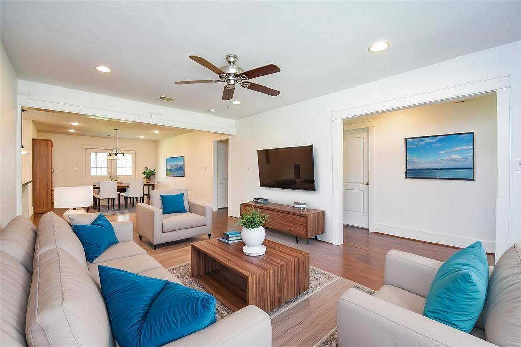 Bright and open living area virtually staged to highlight its generous size and versatility.